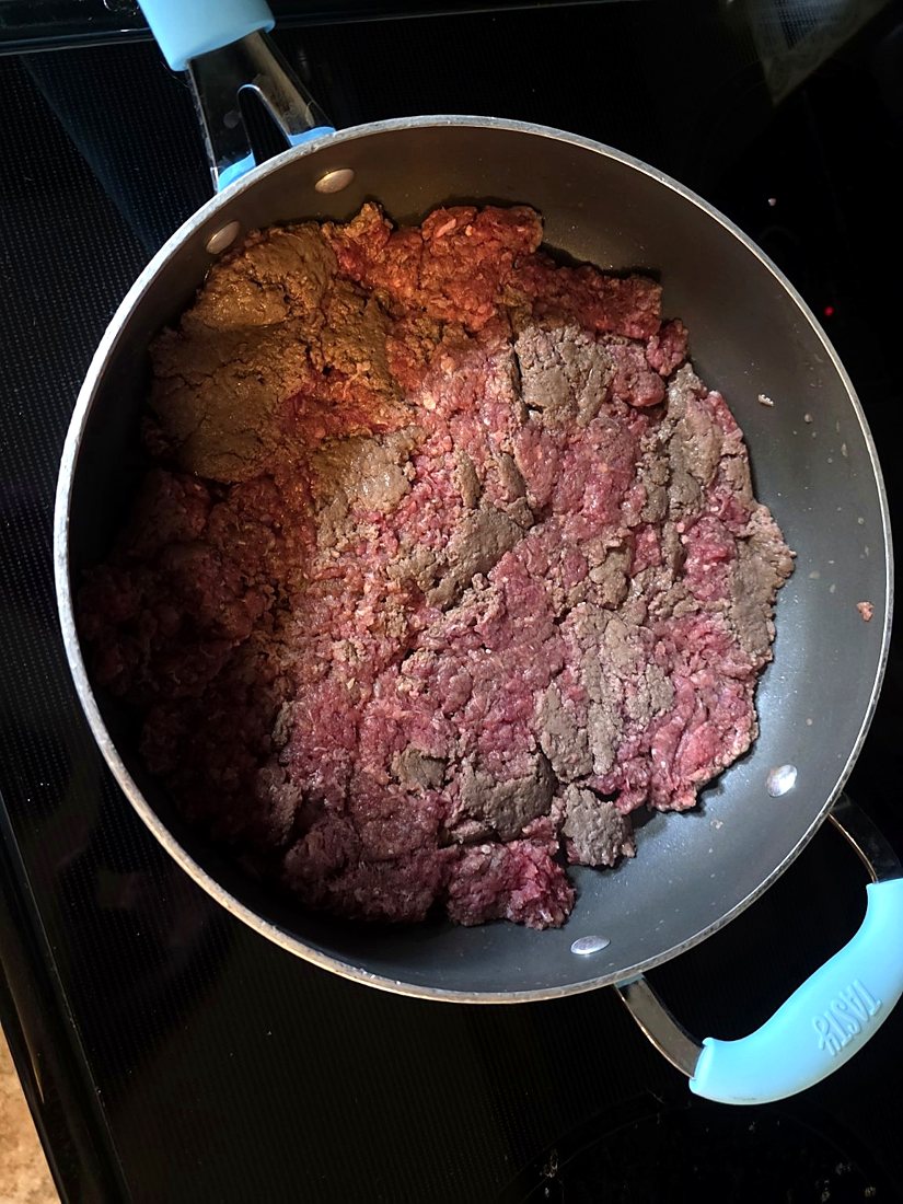 Ground beef browning in a skillet