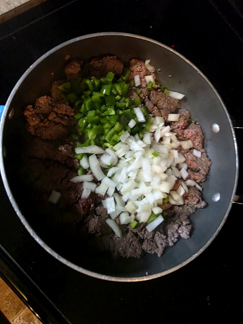 Chopped onion and bell pepper added to ground beef